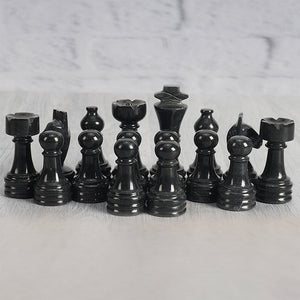 marinara and black chess pieces- chess figures
